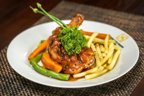 a plate of food with meat and vegetables and french fries at Huluganga Ridge, Kandy in Kandy