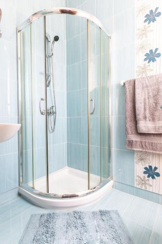 a shower with a glass door in a bathroom at North Side Apartment 1 in Mġarr