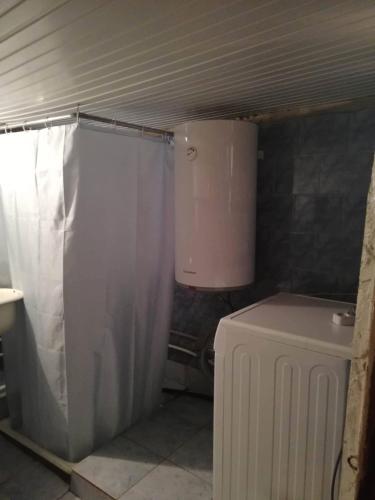 a bathroom with a shower and a toilet in it at Hotel Front Castle in Shatili