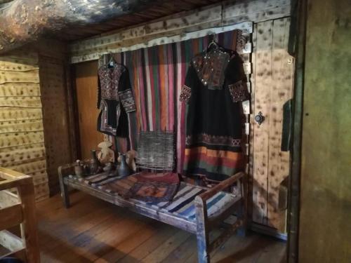 a room with clothes hanging on a wall at Hotel Front Castle in Shatili