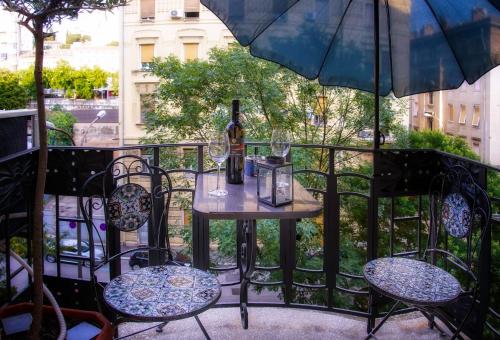 a table with a bottle of wine on a balcony at Room 4 two in Rijeka