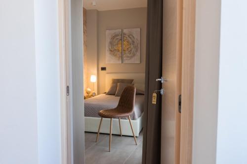 a bedroom with a bed and a chair in it at La Torre del Tempo in Turi