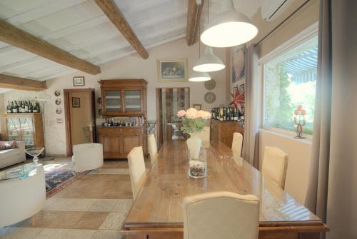 a dining room with a long wooden table and chairs at LAGO GABBIANO PODERe CASANOVA in Pistoia