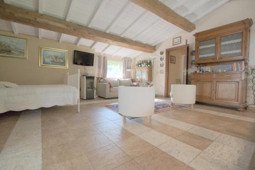 a large living room with a bed and chairs at LAGO GABBIANO PODERe CASANOVA in Pistoia