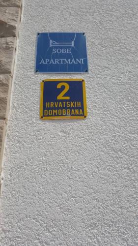 a sign on the side of a building at Kos Apartments in Bol