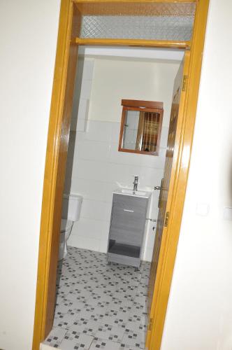 a bathroom with a sink and a mirror at Mekelle Hotel in Mekʼelē