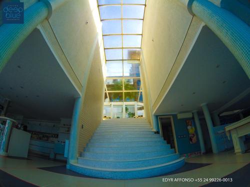 a stairway in a building with a glass ceiling at Residência Angra Deep Blue in Angra dos Reis