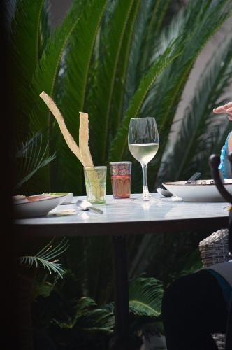 a table with a glass of white wine on it at Hotel Casa Blanca 7 in San Miguel de Allende