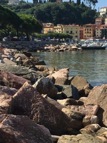 a group of rocks on the shore of a body of water at Affittacamere La Baia Di Lerici in Lerici