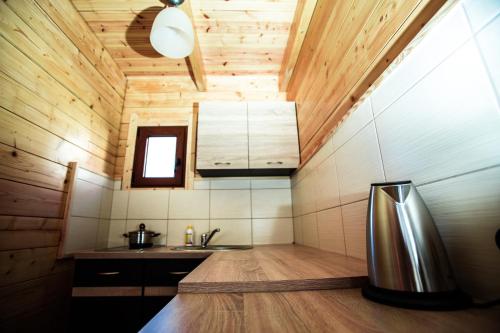a kitchen with a stainless steel refrigerator in a room at Domki Heaven Ustronie Morskie in Ustronie Morskie
