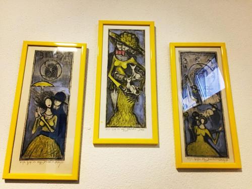 three framed pictures of superheroes on a wall at Hostel Theater 011 in Belgrade