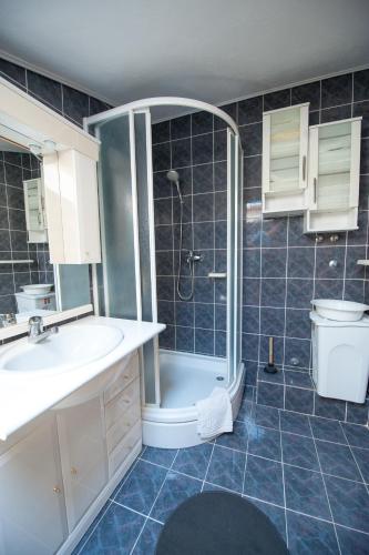 a bathroom with a shower and a sink and a toilet at Apartmani Galić in Ploče