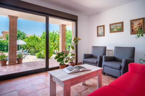 a living room with a couch and chairs and a table at Villa Marín Toledo in Las Nieves