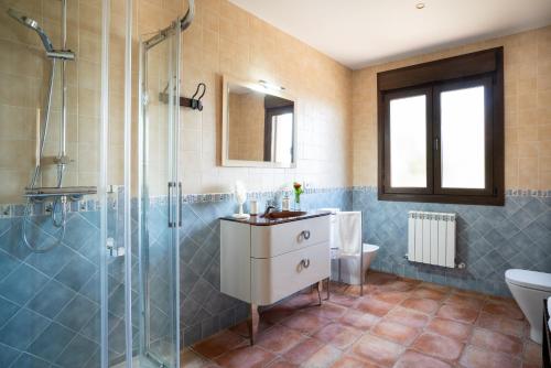 a bathroom with a sink and a glass shower at Villa Marín Toledo in Las Nieves