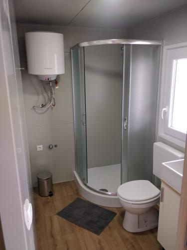 a bathroom with a shower with a toilet and a sink at Mobile Homes Krko Pirovac in Pirovac
