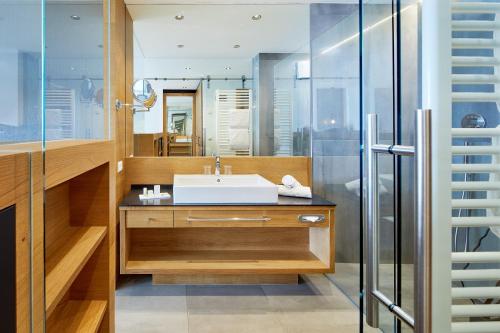 a bathroom with a sink and a shower at Boutique Hotel Eschenlohe in Schenna