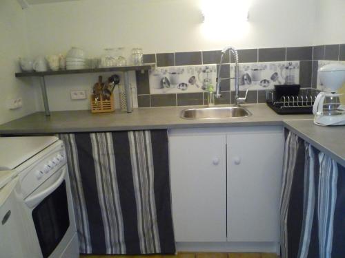 a kitchen with a sink and a counter at Petite maison Normande in Bellou-en-Houlme