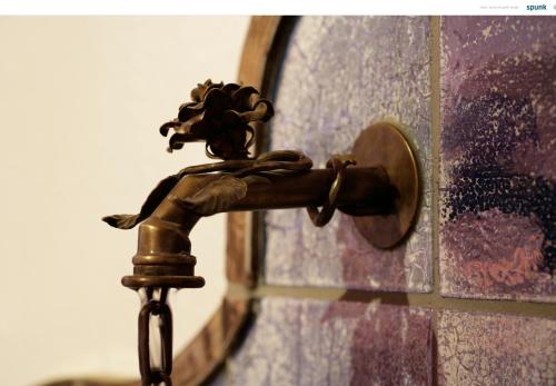 a bronze bathroom faucet in front of a mirror at Landhaus Kössel in Füssen
