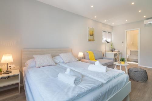 a bedroom with a large bed and a couch at 4 Elements Old Town Views Rooms in Trogir