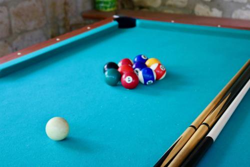 a pool table with balls and cuesticks on it at Traulivi country house in Meta
