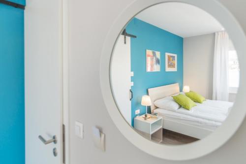 a bedroom with a bed and a mirror at 4 Elements Old Town Views Rooms in Trogir