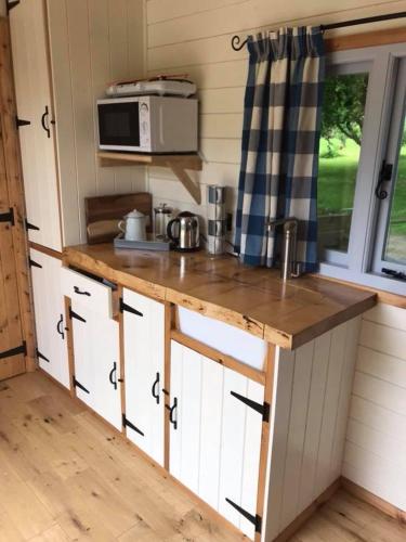 a kitchen with a wooden counter top in a tiny house at Highfields Hideaway in Runswick