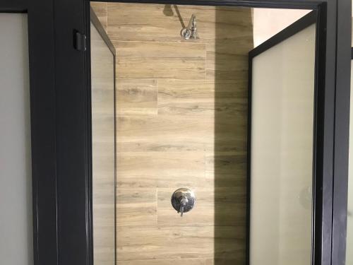 a glass door with a door knob on a wooden wall at Wood Steel & Glass in Marinha Grande