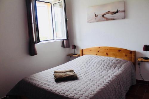 a bedroom with a bed and a window at A FATA DI L'ORTOLO gîtes à la ferme in Sartène
