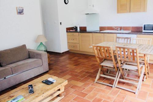 a living room with a couch and a table at A FATA DI L'ORTOLO gîtes à la ferme in Sartène