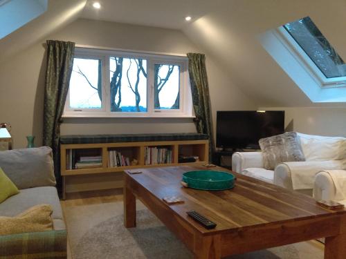 a living room with a couch and a coffee table at Lowood Cottage in Edinburgh