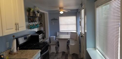 a kitchen with a stove and a table in it at 1st floor cottage! One Block to Beach, Convention Center and Wildwood Crest! in Wildwood