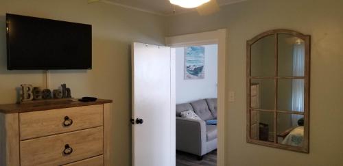 a living room with a couch and a television on the wall at 1st floor cottage! One Block to Beach, Convention Center and Wildwood Crest! in Wildwood