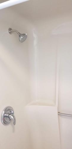 a bath tub with a faucet next to a toilet at 1st floor cottage! One Block to Beach, Convention Center and Wildwood Crest! in Wildwood