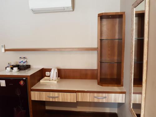 Il comprend une petite cuisine avec un comptoir et un réfrigérateur. dans l'établissement Narisha Guesthouse, à Kupang