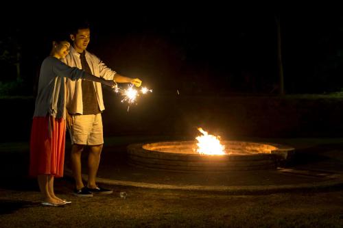 two people standing around a fire fountain with sparklers at The Day Osaka in Osaka