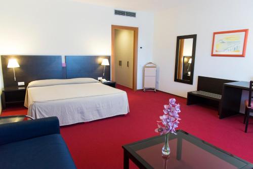 A bed or beds in a room at Park Hotel Centro Congressi