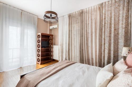 a bedroom with a bed and a window at Acropolis Stylish Suite in Athens