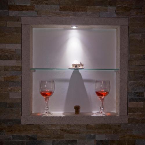 two glasses of wine sitting on a shelf at Rooms and Apartments Villa Dama in Pula