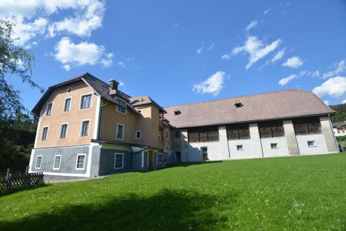 a building on a hill with a green field at PirkerHof in Wenischgraben
