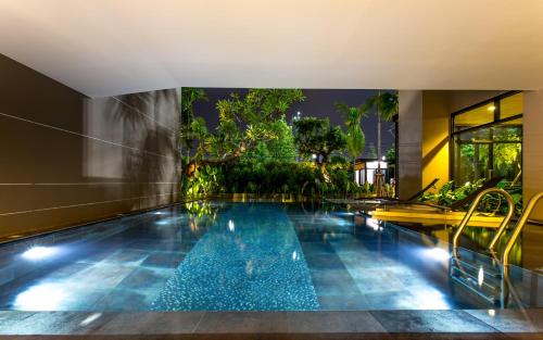 a swimming pool in the middle of a building at Hyde Park Chiangmai in Chiang Mai