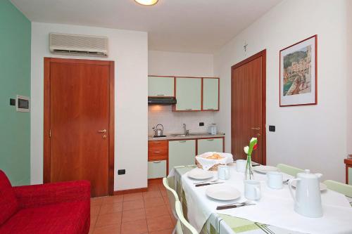 a dining room with a table and a red chair at Nettuno Residence Hotel in Peschiera del Garda