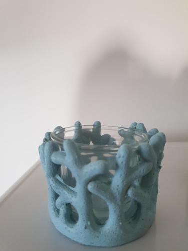 a blue vase sitting on top of a table at Il sogno di Ele in Polignano a Mare