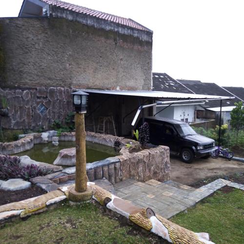 a car parked in front of a building at Hazza syaria homestay in Garut
