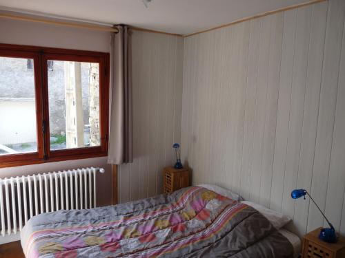 a bedroom with a bed and a window at Chalet Le Bois Noir in Valdeblore