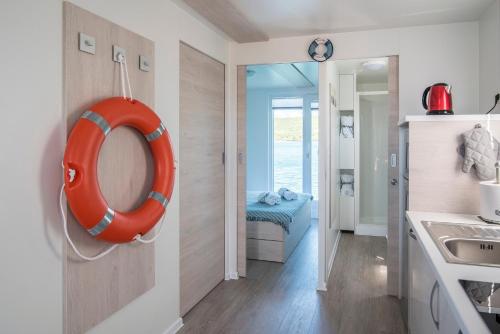a bathroom with an orange lifesaver hanging on the wall at Floating Holiday Home in Punat