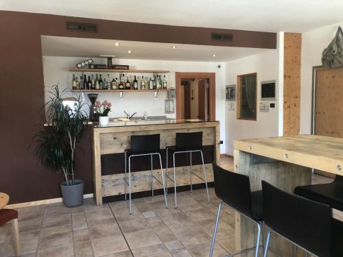 a kitchen with a bar with stools in a room at RTA Torre Del Brenta in Madonna di Campiglio