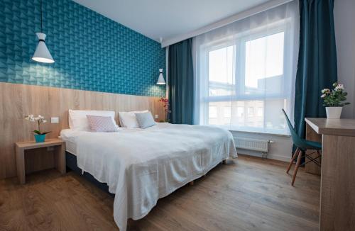 a hotel room with a bed and a window at Unique 3City Apartments - Sea Apartment in Gdańsk
