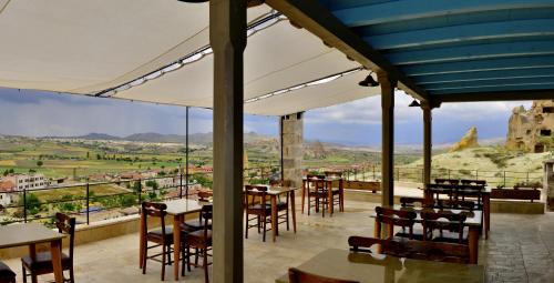 a restaurant with tables and chairs and a view at Seki Cave Suites in Goreme
