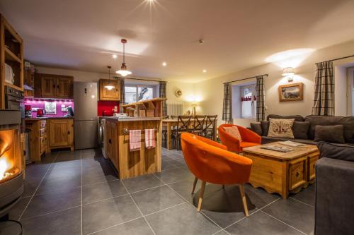 a living room with a couch and a table at Chalet Atelier Chalet Chamonix in Chamonix-Mont-Blanc