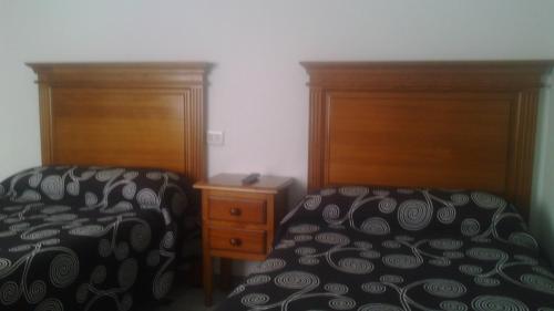 Ένα ή περισσότερα κρεβάτια σε δωμάτιο στο Hostal Cabrera